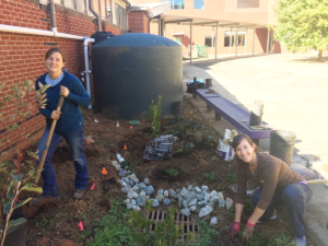 North Carolina Sea Grant's Jane Harrison and Anna Martin of Sea Grant and WRRI help plant native plants next to the Kingswood Elementary School rainwater cistern.
