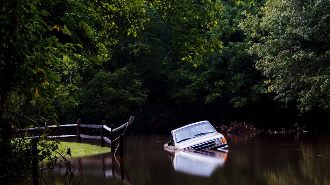 A truck lies inundated by flood waters from the Eno River in Durham after Hurricane Hanna.