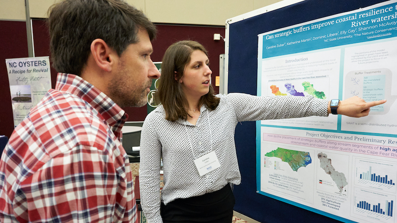 Caroline Zuber presents her poster at the 2022 Annual Conference presentation reception. 